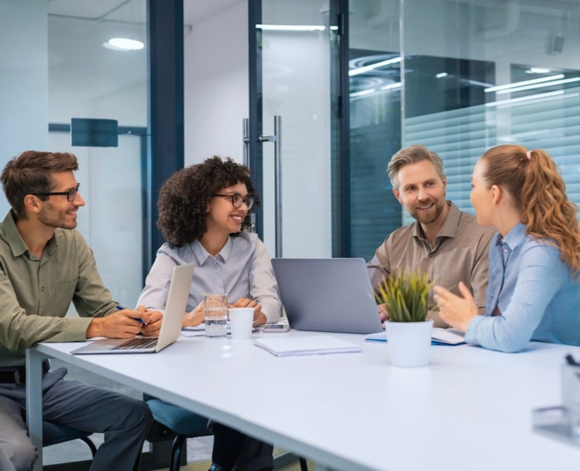 4 casual youngist worker around conference table_2615840869_edited