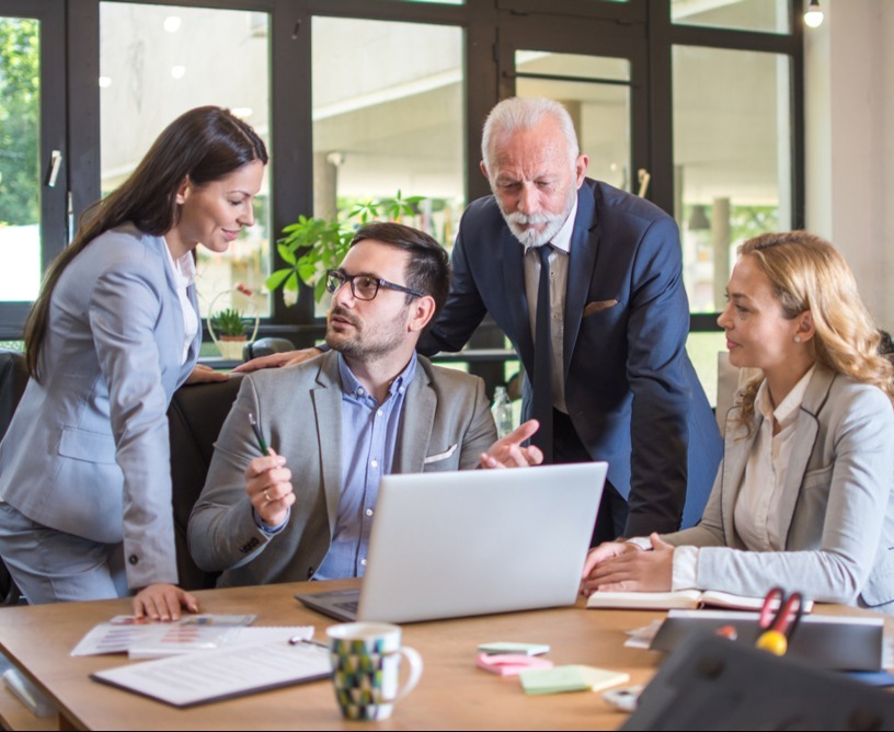 4 professional arond one desk with computer_1840262626_edited