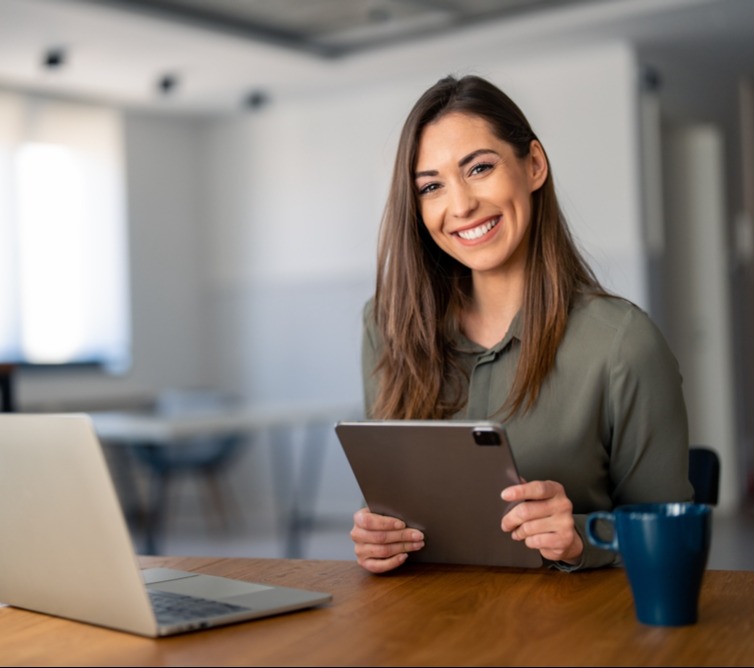 Smiling Brunette Green shirt at Desk_2299269073_edited