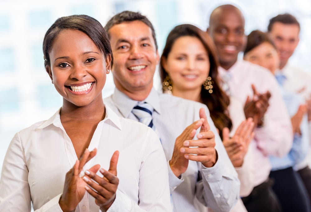 Successful business group applauding at the office