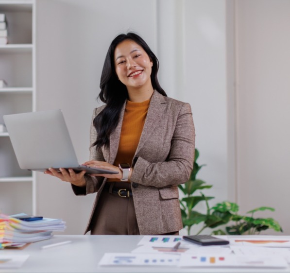 Woman standing at desk in brown_2690243157_edited